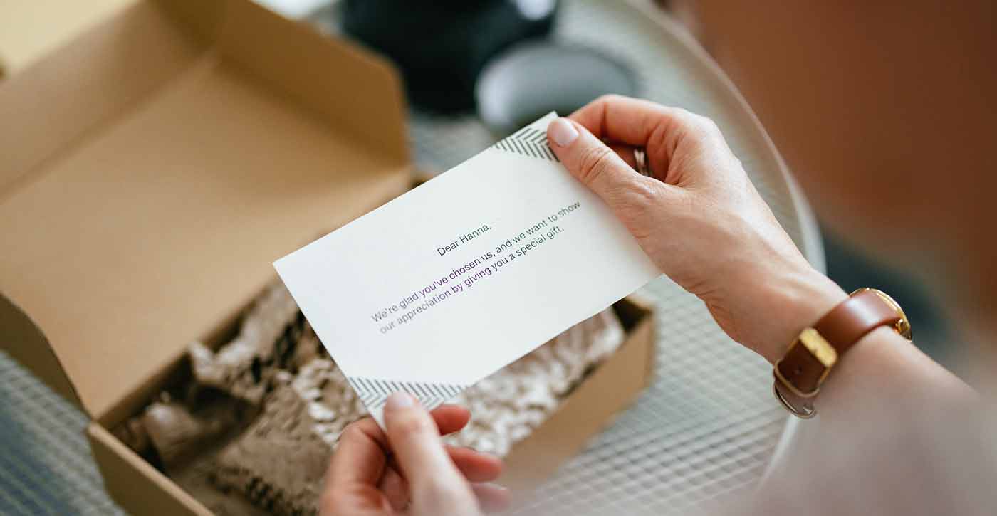 Woman reading a personalized note inside a package 