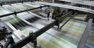 Paper running through fast printing press